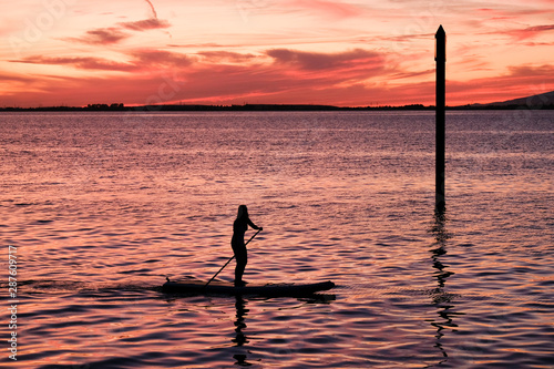 Paddle boarding on the Pacific Ocean at Sunset