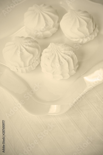 Fototapeta Naklejka Na Ścianę i Meble -  white zephyr close-up on a white plate