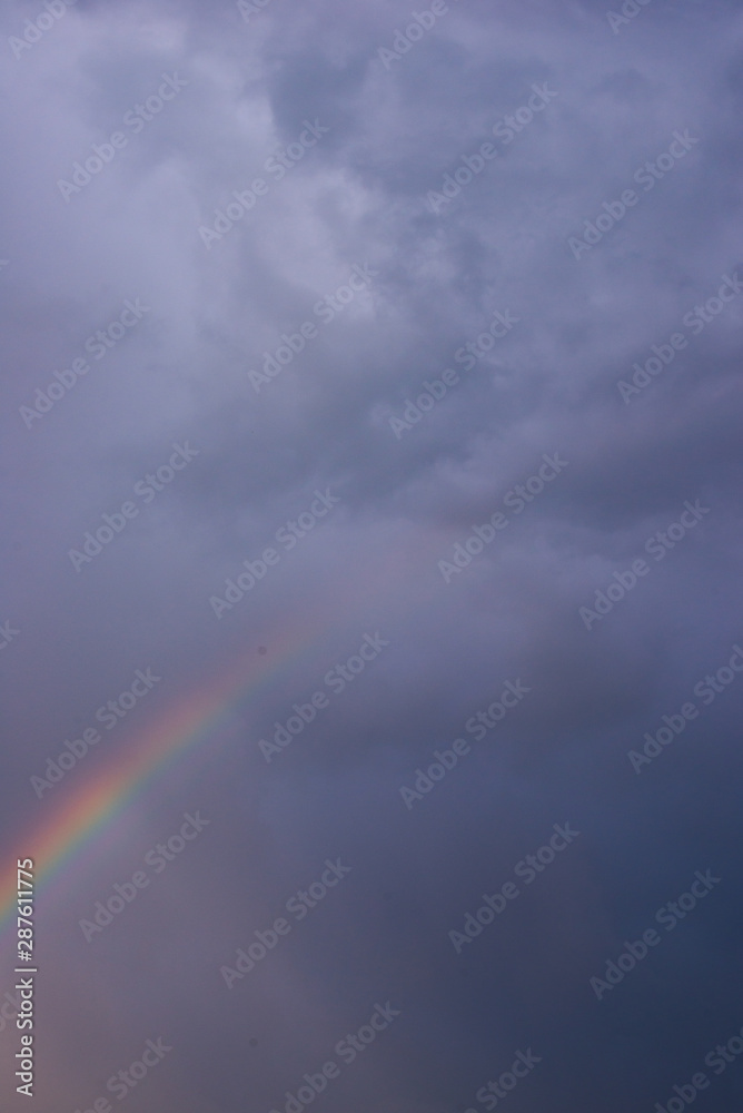 A rainbow among the gloomy sky closeup