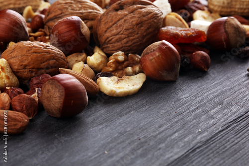 Composition with dried fruits and assorted healthy nuts on rustic background