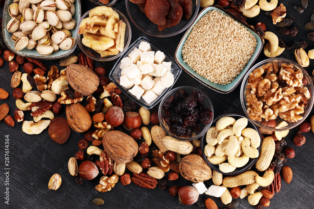 Composition with dried fruits and assorted healthy nuts on rustic background Composition with dried fruits and assorted healthy nuts on rustic background