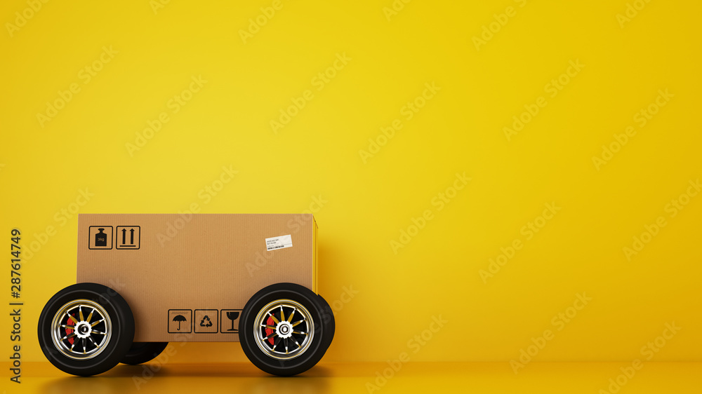 Cardboard box with racing wheels like a car on a yellow background. Fast shipping by road - obrazy, fototapety, plakaty 
