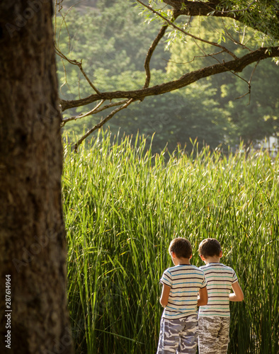 two little brothers hanging out alone in the woods
