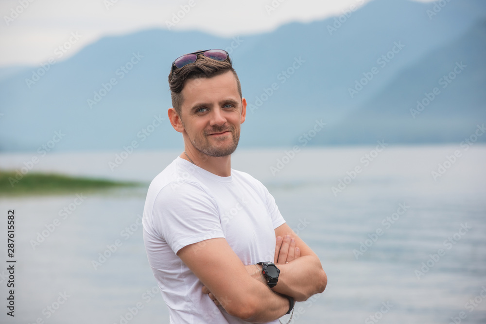 Man portrait on Teletskoye lake in Altai mountains, Siberia, Russia. Beauty summer day.