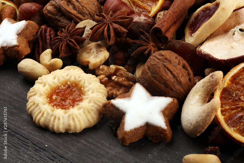 Decoration with christmas cookies. Typical cinnamon stars with fruits and nuts cinnamon