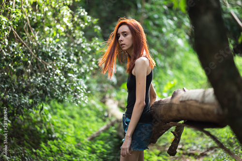 Konstfotografi a skinny redhead girl in a brazilian forest