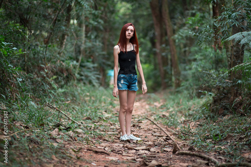 a skinny redhead girl in a brazilian forest © Vagner