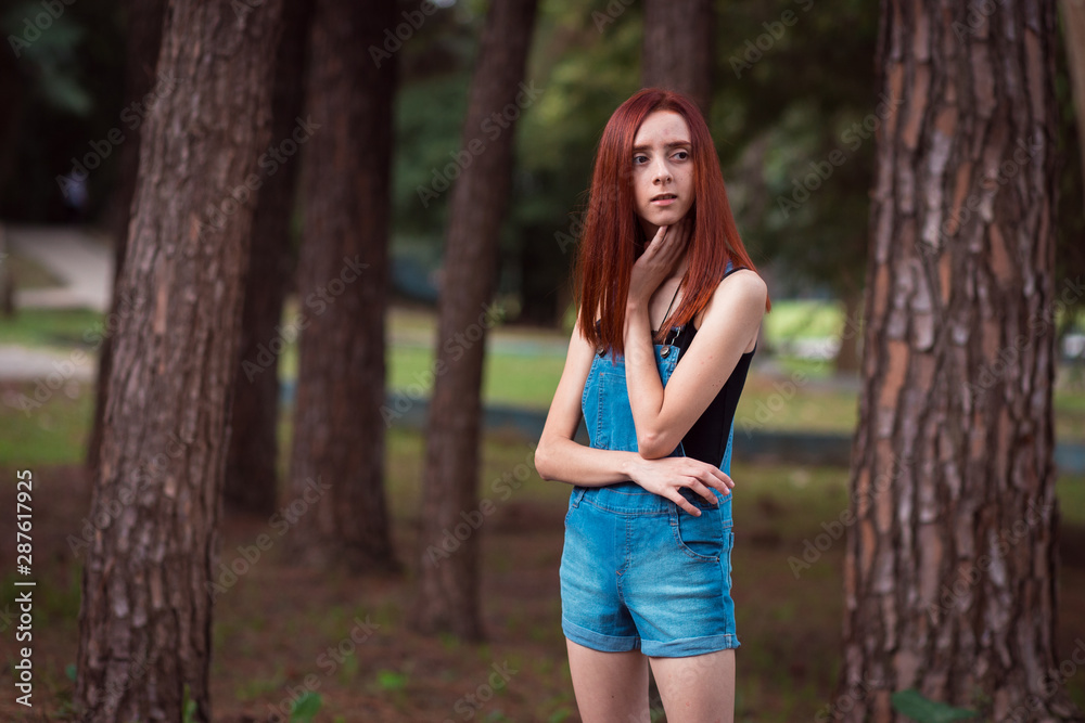 a skinny redhead girl in a brazilian forest