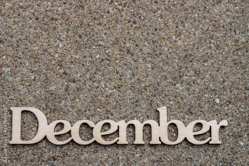 The word December against a background of pavement The word December against a background of pavement
