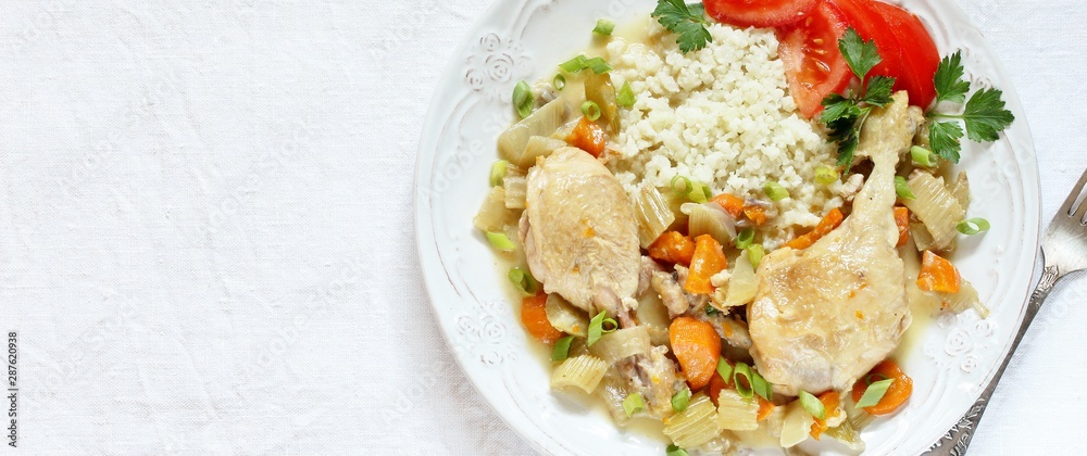 keto dish. Chicken with Cauliflower Rice. low carbohydrates a lot of protein. stewed chicken with celery and carrots. in a white plate on a background of a light tablecloth. top view. copy space. keto dish. Chicken with Cauliflower Rice. low carbohydrates a lot of protein. stewed chicken with celery and carrots. in a white plate on a background of a light tablecloth. top view. copy space.