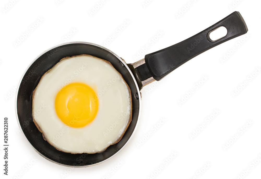 Single fried egg in very small pan with non-stick surface isolated on white background, top view. Single fried egg in very small pan with non-stick surface isolated on white background, top view.