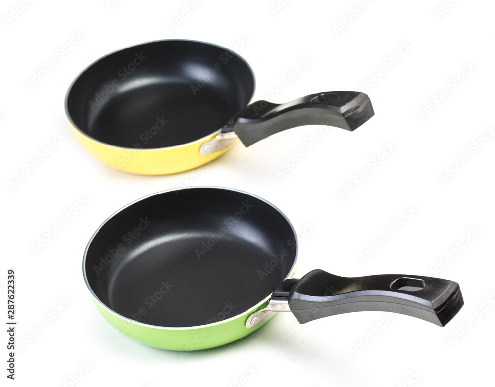Pair of very small frying pans with non-stick surface, isolated on a white background. Pair of very small frying pans with non-stick surface, isolated on a white background.