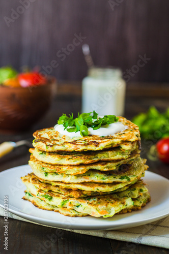 zucchini fritters healthy vegetable recipe, ingredients are zucchini, carrots, garlic, parsley and eggs