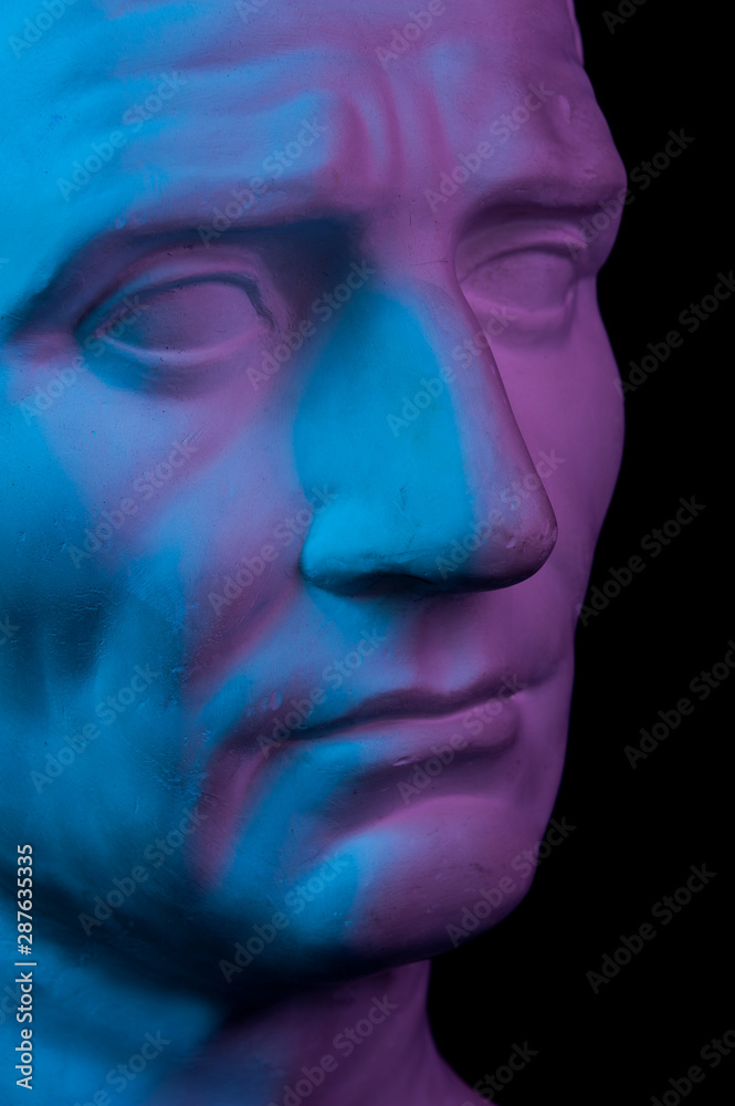 Gypsum copy of ancient statue Augustus head isolated on black background. Plaster sculpture man face. Gypsum copy of ancient statue Augustus head isolated on black background. Plaster sculpture man face.