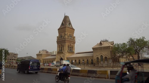 Karachi Empress Market Saddar at Shahrah-e-Liaquat Street Side View with Busy Traffic on a Cloudy Day photo