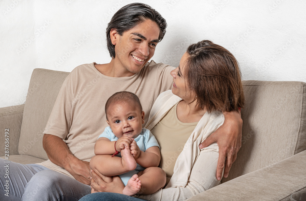 Young parents enjoying their newborn. Love and affection for their child Young parents enjoying their newborn. Love and affection for their child