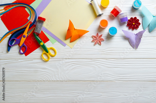 Composition with papercraft supplies on wooden white desk for kids activity