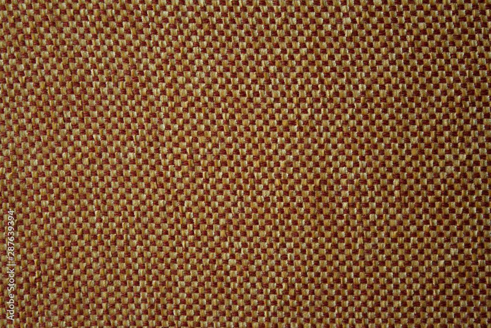 Texture of a woven material with with yellow and brown threads Texture of a woven material with with yellow and brown threads
