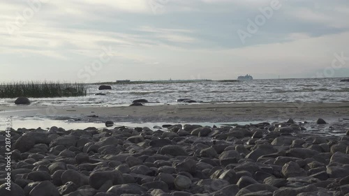 View from the coast on the high-speed Raketa (hydrofoil) ship and white cruise ship going across the Gulf of Finland against the background of Ostorf Kotlin and the cities of Kronstadt photo