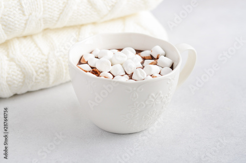 Cup of hot chocolate with marshmallows on a gray concrete background. 