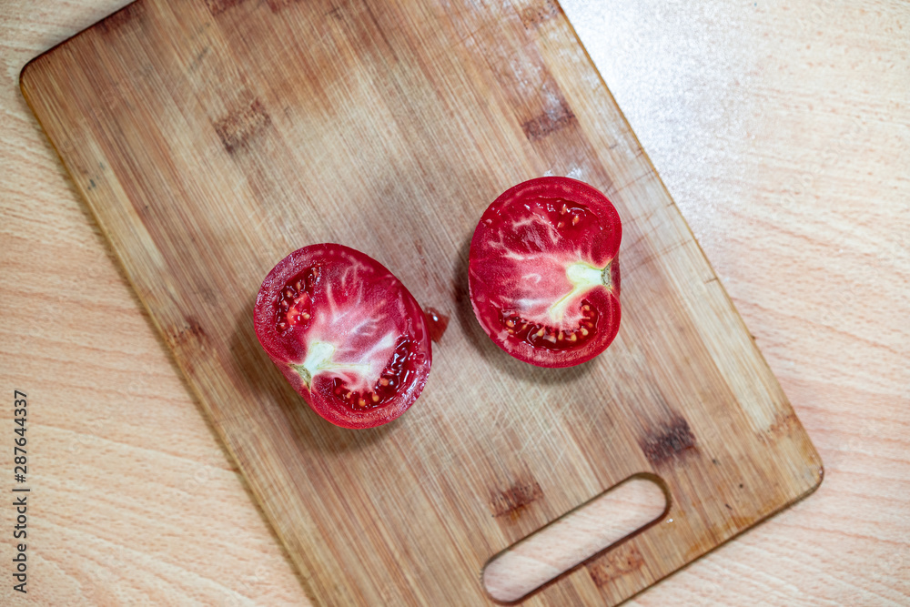 Red tomato on a cutting board Red tomato on a cutting board