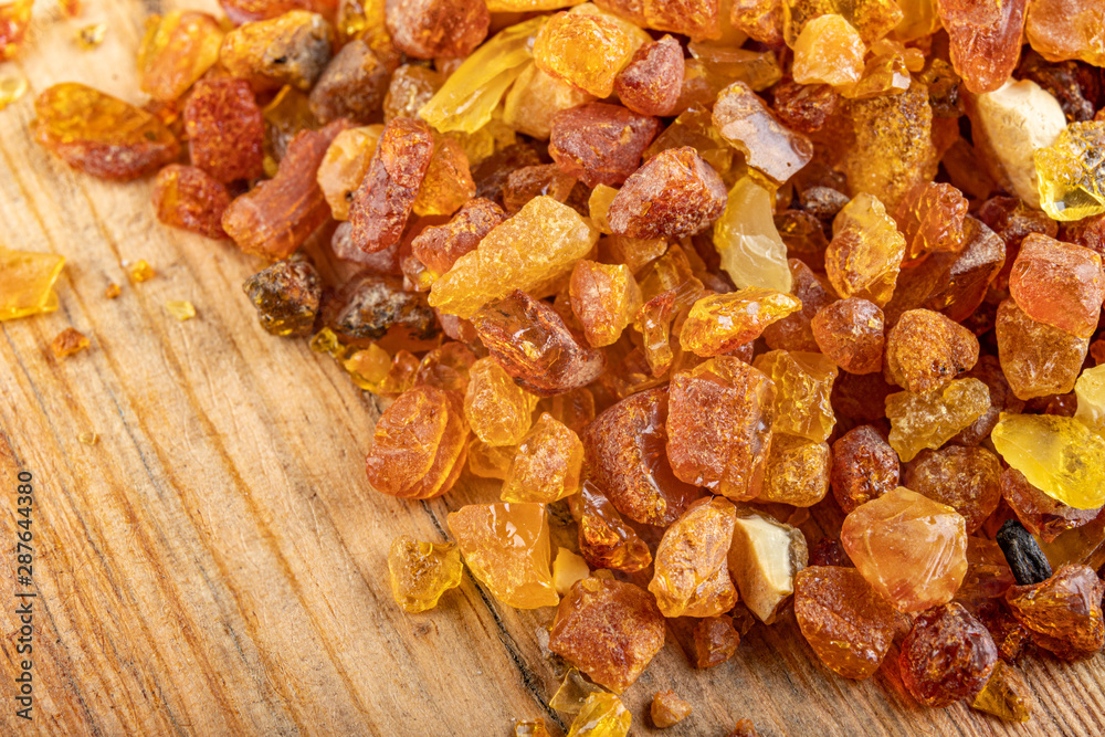 Small raw amber on a wooden table. A precious find from the coast of Central Europe. Small raw amber on a wooden table. A precious find from the coast of Central Europe.
