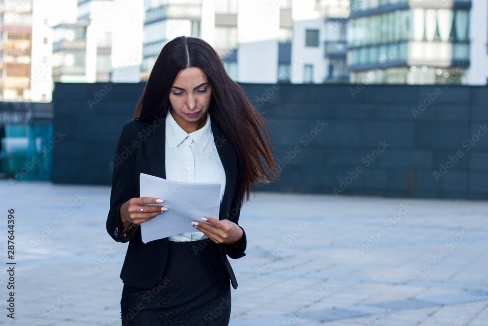 Sexy hot busy secretary businesswoman or young beautiful office female  worker or employee standing outside business centre, workplace, looking at  papers, reading documents.. foto de Stock | Adobe Stock