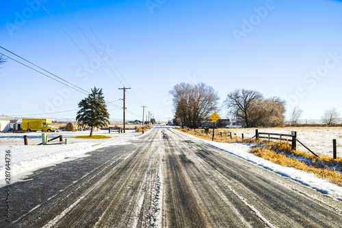 Icy Country Road In A Snowy Farmland Small Town On A Bright And Sunny Winter Day, Ellensburg, WA, USA photo