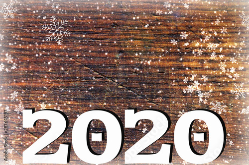 2020. Texture dark wood ilfri 2020.New year background. Retro wooden table. Rustic background. White snowflakes , snow, bokeh. Copy space.Background Christmas, new year.Dark wood texture with white sn photo