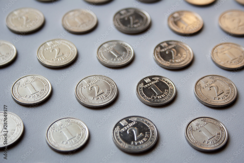 Ukrainian coins pattern of one hryvnia and two hryvnias value on white background Ukrainian coins pattern of one hryvnia and two hryvnias value on white background
