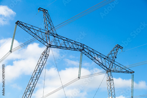 electricity distribution station. high voltage electric transmission tower.electricity transmission pylon silhouetted against blue sky at dusk © bukhta79