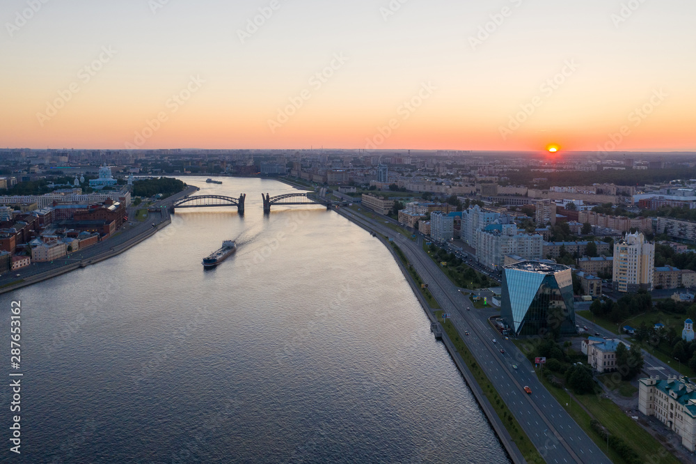 Saint Petersburg. Russia. Bolsheokhtinsky bridge lifted. Bridge of Peter the Great at sunset. The drawbridges of Petersburg. Navigation on the Neva River. Cities of Russia. Panorama of St. Petersburg.