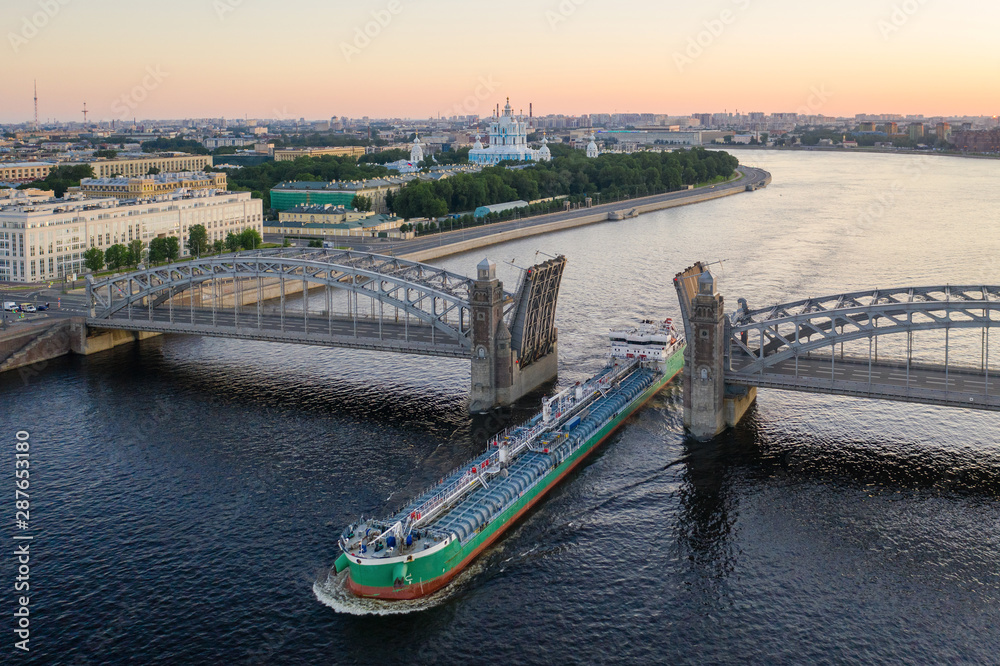 Naklejka premium Saint Petersburg. Russia. Bolsheokhtinsky bridge lifted. Bridge of Peter the Great at sunset. The drawbridges of Petersburg. Navigation on the Neva River. Cities of Russia. Panorama of St. Petersburg.