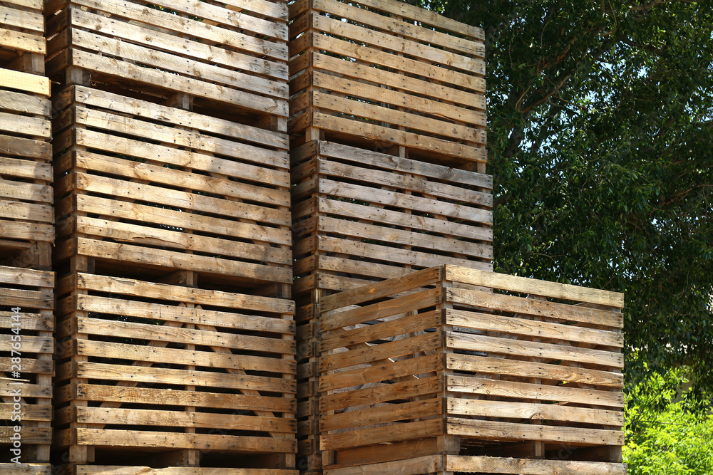 Pile of empty wooden crates outdoors on sunny day Pile of empty wooden crates outdoors on sunny day