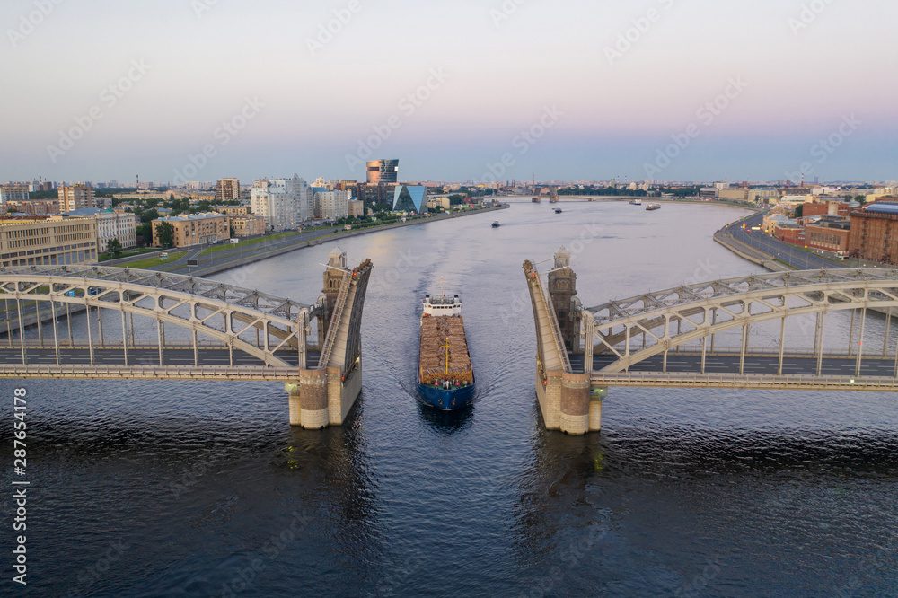 Saint Petersburg. Russia. Bolsheokhtinsky bridge lifted. Bridge of Peter the Great at sunset. The drawbridges of Petersburg. Navigation on the Neva River. Cities of Russia. Panorama of St. Petersburg.