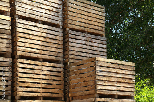 Pile of empty wooden crates outdoors on sunny day