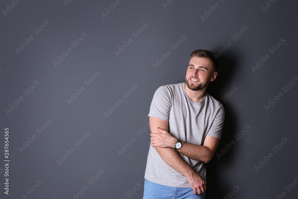 Portrait of handsome happy man on grey background, space for text Portrait of handsome happy man on grey background, space for text
