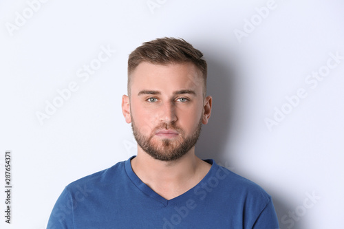 Portrait of handsome serious man on white background