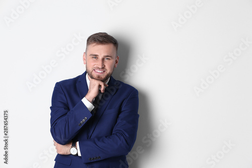 Portrait of happy man in office suit on white background