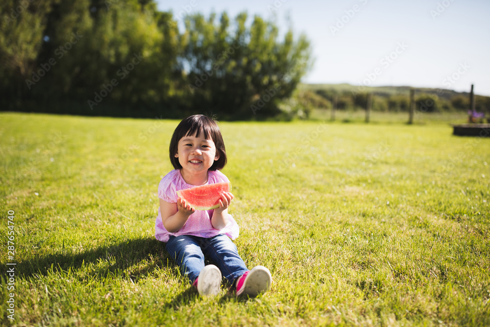 toddler girl eating watermelon at home garden toddler girl eating watermelon at home garden