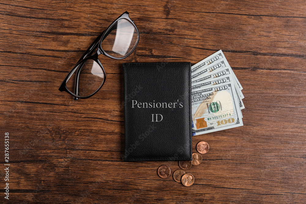 Pension certificate with American money and glasses on wooden table, flat lay