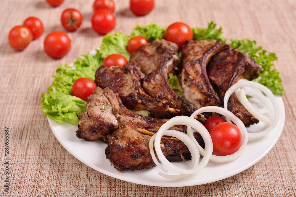 barbecue on a plate with herbs and vegetables. Russian restaurant. The concept of the menu. barbecue on a plate with herbs and vegetables. Russian restaurant. The concept of the menu.