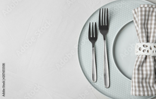 Beautiful table setting on grey background, top view. Space for text