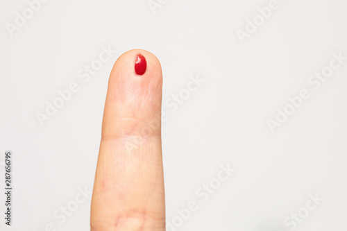 Wall Mural A closeup view on the small blood drop on a caucasian finger, caused by a lancet needle prick for a glucometer device, measuring sugar levels in the body