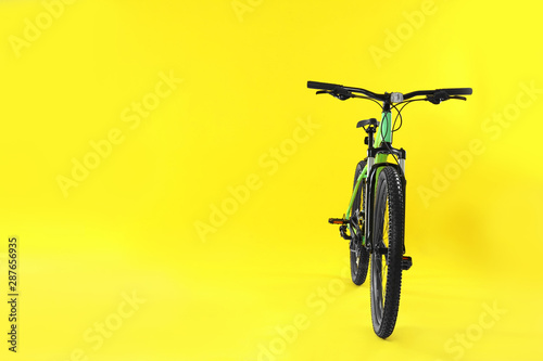 Modern bicycle on yellow background. Space for text