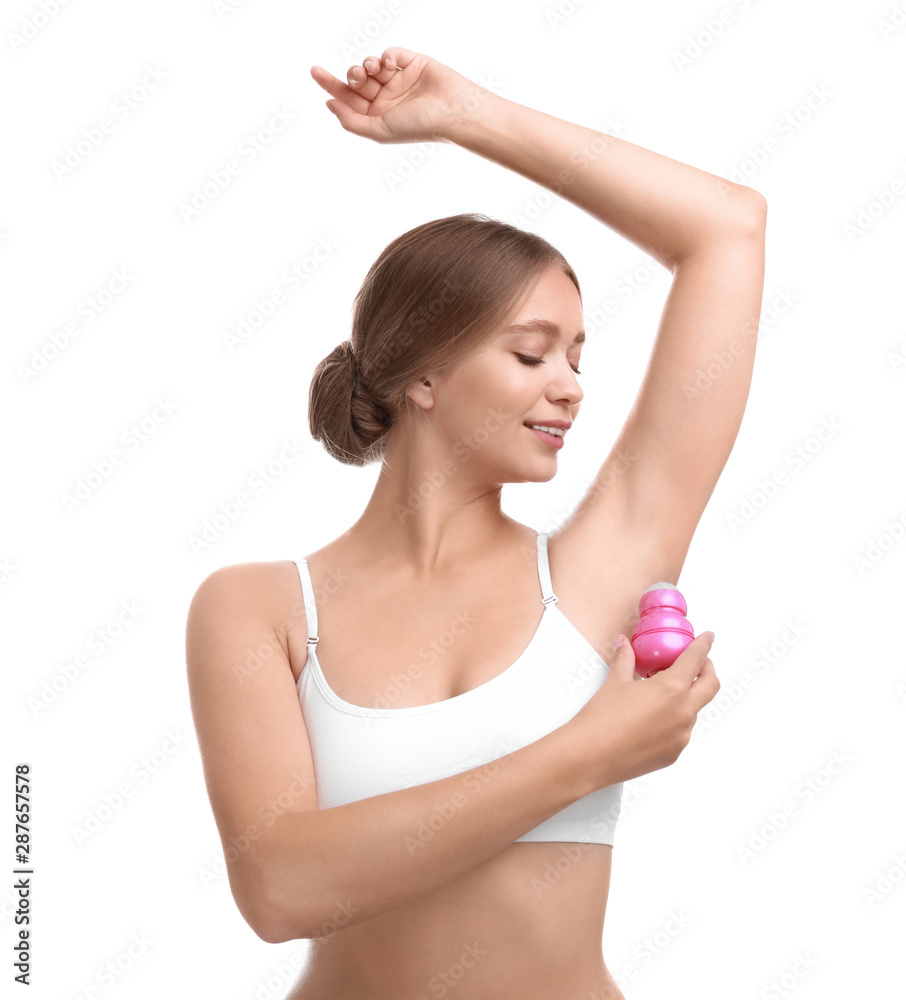 Young woman applying deodorant to armpit on white background Young woman applying deodorant to armpit on white background