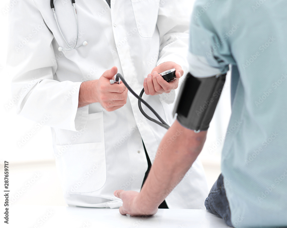 Doctor measuring blood pressure with sphygmomanometer Doctor measuring blood pressure with sphygmomanometer