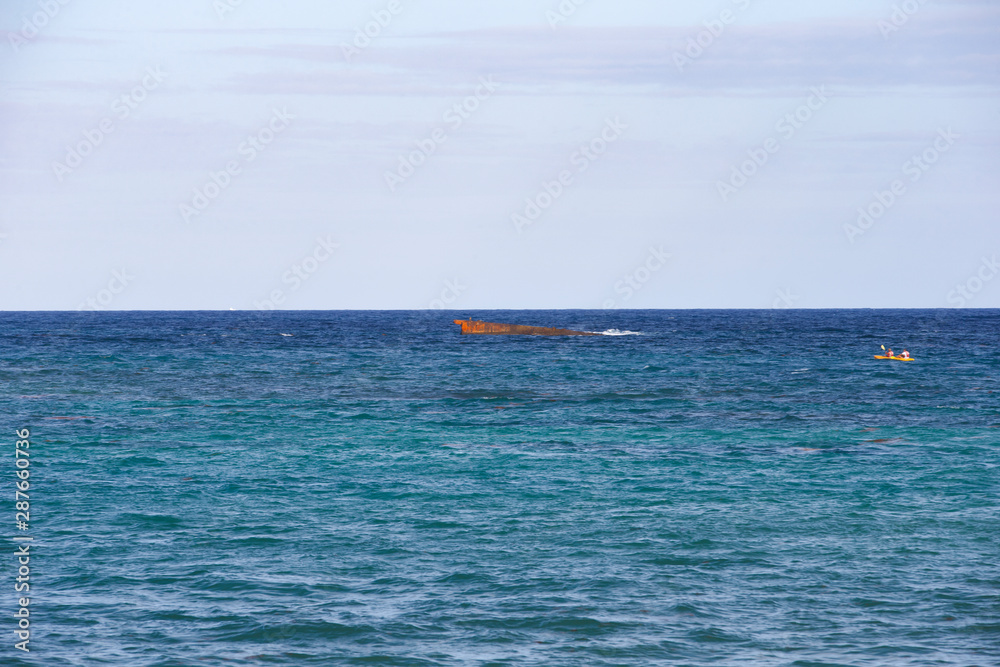 Tropics, Atlantic Ocean. Rusty hull sunken ship.