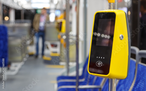 Bus with validator for self-payment. Fare control without a conductor. Non-cash transport payment. Terminal of payment for travel by transport or bank cards. Public city passenger transport.