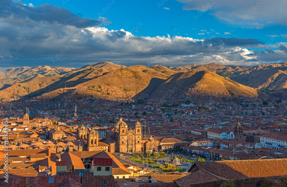 The complete skyline (aerial view) of the historic city center of Cusco (ancient Inca capital) with a colonial style architecture at sunset, Cusco Province, Peru, South America.